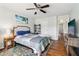 Comfortable bedroom with a ceiling fan, hardwood floors, neutral paint, and cozy décor at 776 Amos Ln, Kennesaw, GA 30152