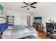 Spacious bedroom offers natural light, wood floors, ceiling fan, and TV at 776 Amos Ln, Kennesaw, GA 30152