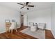 Bedroom with hardwood floors, ceiling fan, seating area, and neutral paint at 776 Amos Ln, Kennesaw, GA 30152