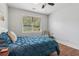 Peaceful bedroom featuring hardwood floors, a ceiling fan, and bright blue bedding at 776 Amos Ln, Kennesaw, GA 30152