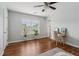 Bedroom with hardwood floors, ceiling fan, plants and a chair at 776 Amos Ln, Kennesaw, GA 30152