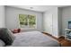 Cozy bedroom featuring a gray comforter, a study area, and a view of the outdoors at 776 Amos Ln, Kennesaw, GA 30152