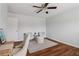 Bedroom with hardwood floors, ceiling fan, seating area, and neutral paint at 776 Amos Ln, Kennesaw, GA 30152
