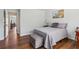 Cozy bedroom features hardwood floors, a sitting bench, and plenty of natural light at 776 Amos Ln, Kennesaw, GA 30152