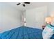 Inviting bedroom features bright blue bedding, hardwood floors, and a ceiling fan at 776 Amos Ln, Kennesaw, GA 30152