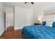 Serene bedroom with hardwood floors, a ceiling fan, and bright blue bedding at 776 Amos Ln, Kennesaw, GA 30152