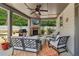 Relaxing covered patio with a stone fireplace, outdoor TV, comfortable seating, and backyard view at 776 Amos Ln, Kennesaw, GA 30152