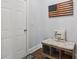 Cozy entryway showcasing a cushioned bench with storage and an American flag decor at 776 Amos Ln, Kennesaw, GA 30152