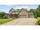 Impressive stone-front home boasting a large, well-manicured yard and a three-car garage at 776 Amos Ln, Kennesaw, GA 30152