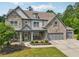 Handsome two-story home with a stone facade, covered porch and professional landscaping at 776 Amos Ln, Kennesaw, GA 30152