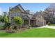 Beautiful two-story home with a stone facade, covered porch and an attached three-car garage at 776 Amos Ln, Kennesaw, GA 30152