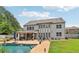 Rear exterior showing a large two-story home with an outdoor living space, pool, and well-maintained lawn at 776 Amos Ln, Kennesaw, GA 30152