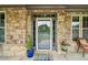 Inviting front entrance with a decorative wreath on the glass door and potted plants flanking the entrance at 776 Amos Ln, Kennesaw, GA 30152