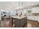 Modern kitchen with granite countertops, large island with pendant lighting, and hardwood floors, seamlessly connects to the living room at 776 Amos Ln, Kennesaw, GA 30152