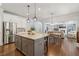 Kitchen showcasing a large island, stainless steel appliances, granite countertops, and hardwood floors that open to the living room at 776 Amos Ln, Kennesaw, GA 30152