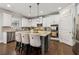 Stylish kitchen featuring white cabinetry, granite countertops, stainless steel appliances, and an island with barstool seating at 776 Amos Ln, Kennesaw, GA 30152