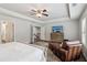 Bright main bedroom featuring a TV, a leather chair, and access to the staircase and bathroom at 776 Amos Ln, Kennesaw, GA 30152