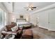 A well-lit main bedroom offers a seating area, tray ceiling, ceiling fan, and an area rug at 776 Amos Ln, Kennesaw, GA 30152