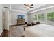 Comfortable main bedroom featuring a bed, dresser, and seating area beneath a tray ceiling at 776 Amos Ln, Kennesaw, GA 30152
