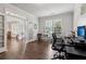 Spacious office with hardwood floors, large windows, and a functional desk setup; perfect for productivity and focus at 776 Amos Ln, Kennesaw, GA 30152