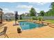 Private backyard pool surrounded by a stamped concrete patio, lush landscaping, and seating creating an outdoor oasis at 776 Amos Ln, Kennesaw, GA 30152