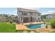 Inviting backyard featuring a swimming pool, outdoor seating, covered patio, and nicely landscaped garden areas at 776 Amos Ln, Kennesaw, GA 30152