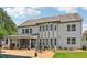 Rear exterior showcasing a covered patio, lush greenery, and inviting outdoor space with a pool at 776 Amos Ln, Kennesaw, GA 30152