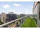 Open balcony showcasing panoramic city views with artificial grass flooring and modern seating at 860 Peachtree Ne St # 2801, Atlanta, GA 30308