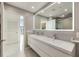 Modern bathroom featuring a double sink vanity, large mirror with LED lighting, and a separate doorway at 860 Peachtree Ne St # 2801, Atlanta, GA 30308