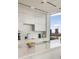 Modern kitchen featuring white cabinets, a marble countertop, and stunning views of the cityscape through large windows at 860 Peachtree Ne St # 2801, Atlanta, GA 30308