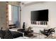 Stylish living room features modern decor, unique art pieces, and balcony access with city views at 860 Peachtree Ne St # 2801, Atlanta, GA 30308