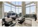 Chic living room with floor-to-ceiling windows showcasing panoramic city views and contemporary furnishings at 860 Peachtree Ne St # 2801, Atlanta, GA 30308