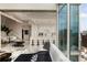 Open concept living area with a modern kitchen, bar seating, and expansive windows for city views at 860 Peachtree Ne St # 2801, Atlanta, GA 30308