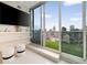 Beautiful main bedroom with amazing city views from the large windows and cozy seating at 860 Peachtree Ne St # 2801, Atlanta, GA 30308