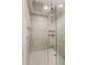 Luxurious shower with rainfall showerhead, handheld sprayer, and modern gray tiling at 860 Peachtree Ne St # 2801, Atlanta, GA 30308