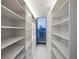 Spacious walk-in closet with ample shelving, drawers, and floor-to-ceiling window overlooking city views at 860 Peachtree Ne St # 2801, Atlanta, GA 30308
