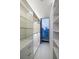 Bright walk-in closet with glass shelving, drawers, built-in lighting, and cityscape views at 860 Peachtree Ne St # 2801, Atlanta, GA 30308