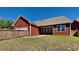 This fenced backyard complements the red home's exterior, adding character and curb appeal at 9866 Garden Hill Ln, Douglasville, GA 30135