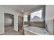 Main bathroom featuring soaking tub, glass enclosed shower, tile floors, and a window at 9866 Garden Hill Ln, Douglasville, GA 30135