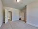 Bedroom with carpeted floors, white walls, and two doorways at 9866 Garden Hill Ln, Douglasville, GA 30135
