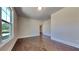 Bright room with hardwood floors, large window, and neutral walls provides a serene and inviting space at 9866 Garden Hill Ln, Douglasville, GA 30135