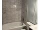 Bathroom features tiled walls, shower head, and a bathtub at 172 Camp Sunrise Nw Rd, Cartersville, GA 30121