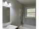 Bathroom features tiled walls, shower head, sink, and window at 172 Camp Sunrise Nw Rd, Cartersville, GA 30121