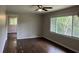 Bedroom with dark hardwood floors, neutral walls, white trim, and a ceiling fan with lighting at 172 Camp Sunrise Nw Rd, Cartersville, GA 30121