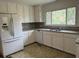 Kitchen featuring white cabinets, granite countertops, stainless sink and a white refrigerator at 172 Camp Sunrise Nw Rd, Cartersville, GA 30121