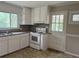 Kitchen with white cabinets, white appliances, granite counters, and a window above the sink at 172 Camp Sunrise Nw Rd, Cartersville, GA 30121