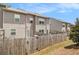 Exterior view of townhome featuring a private, fenced backyard and patio at 1884 Plainsboro Dr, Lithonia, GA 30058
