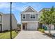 Charming two-story home with gray siding, a brick facade, and a convenient attached garage at 1884 Plainsboro Dr, Lithonia, GA 30058