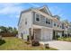 View of the side and front of a two-story home with an attached garage and well-maintained lawn at 1884 Plainsboro Dr, Lithonia, GA 30058