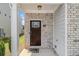 Welcoming front entryway with brick accents and a decorative welcome mat, adding charm and character at 1884 Plainsboro Dr, Lithonia, GA 30058